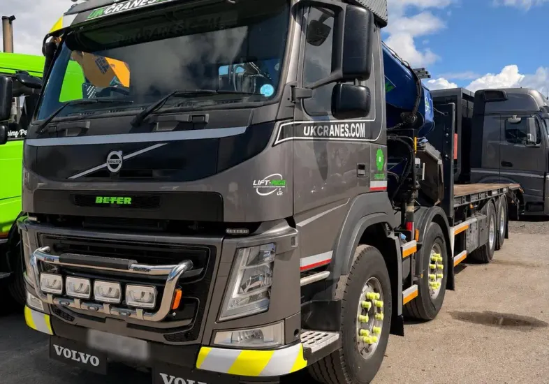 Grey Volvo crane lorry parked in a yard