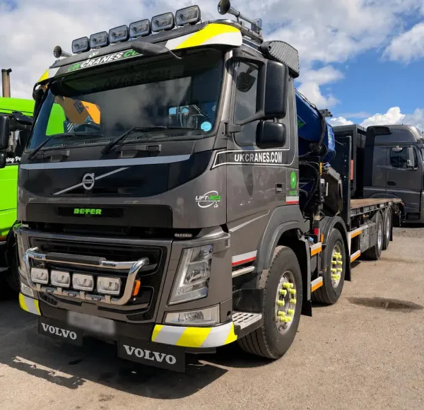 Grey Volvo crane lorry parked in a yard