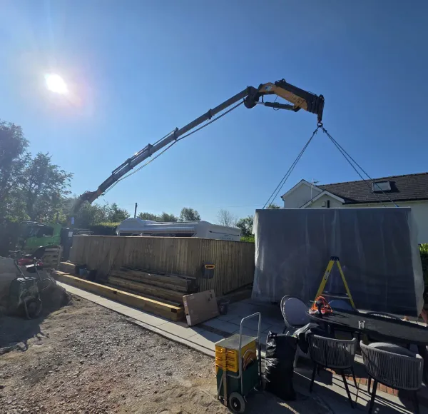 HIAB crane lifting a shed into position