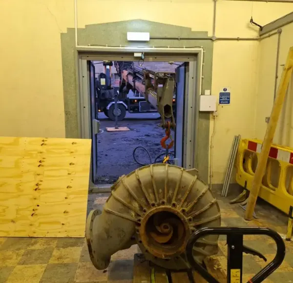 Industrial machinery being removed through a plant room doorway