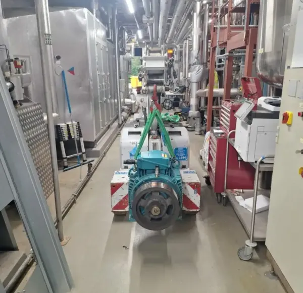 Machinery being moved along a factory corridor