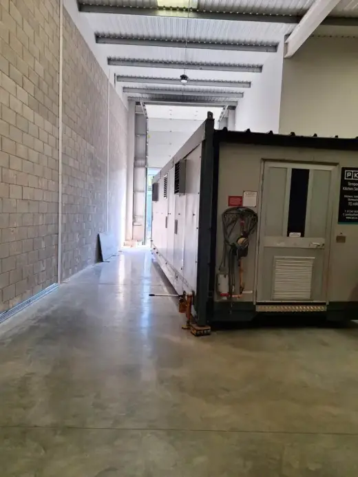 Portable cabin inside a long warehouse corridor