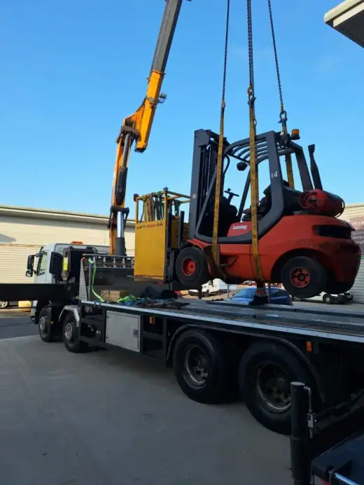 HIAB crane lifting a forklift onto a lorry