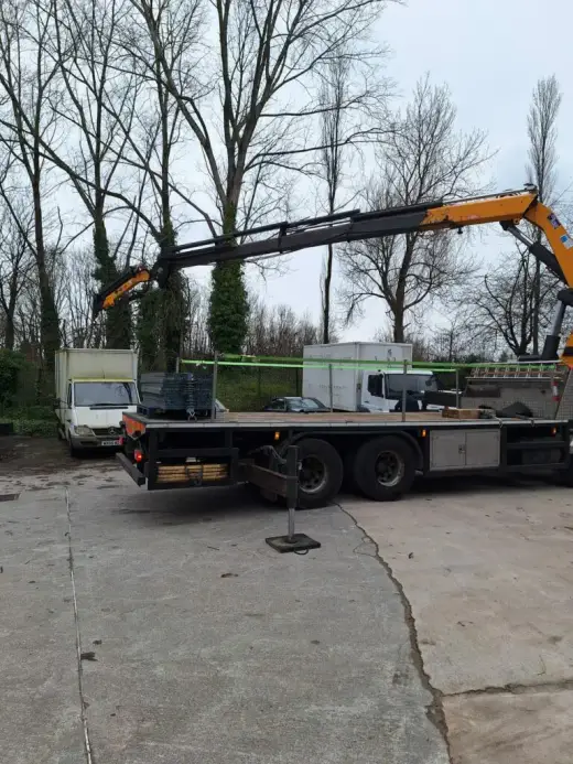 HIAB lorry with its crane unfolded in a yard
