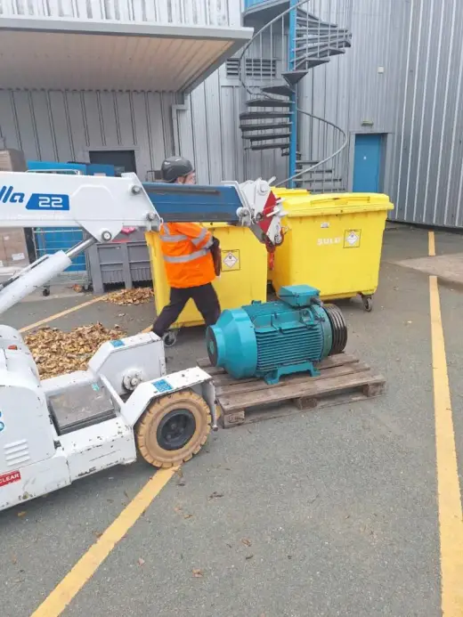 Operative beside a pick-and-carry crane and electric motor