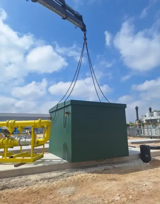 HIAB crane lifting a green electrical kiosk