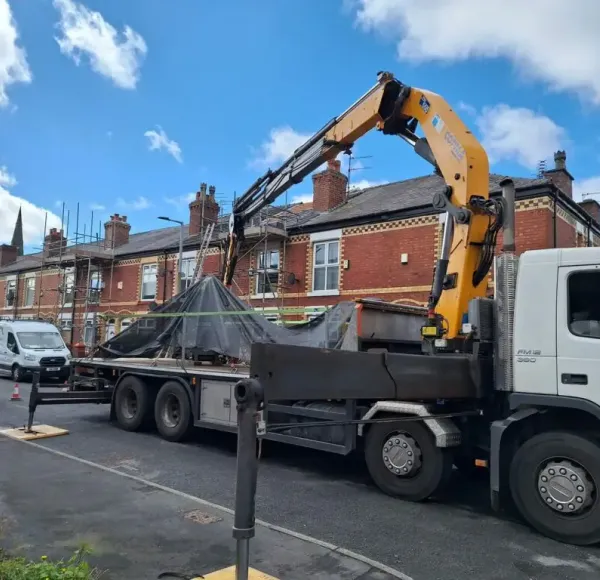 HIAB crane lorry lifting a load on a residential street