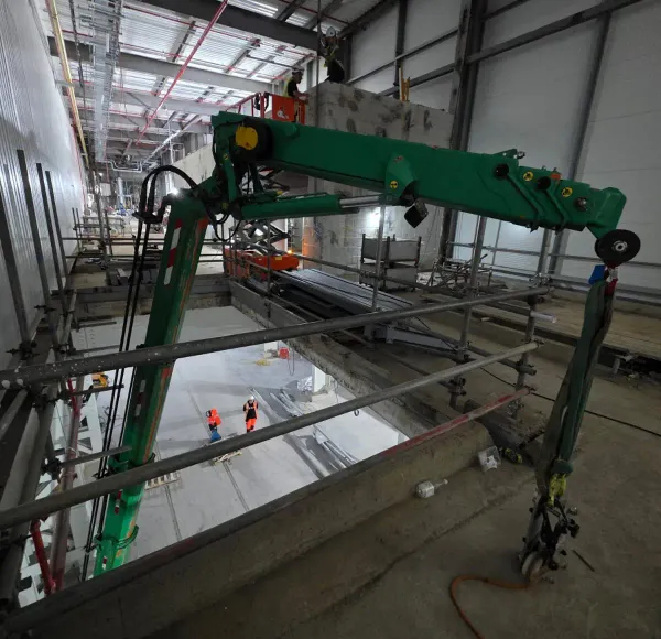 Spider crane boom inside an industrial building