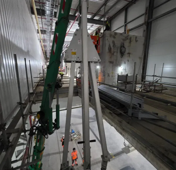 Spider crane lifting in a tall plant room