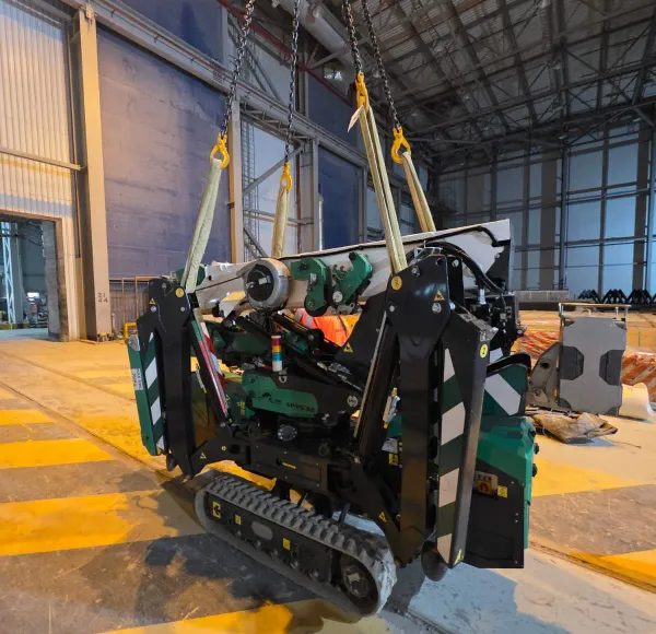Spider crane on a yellow platform inside a building