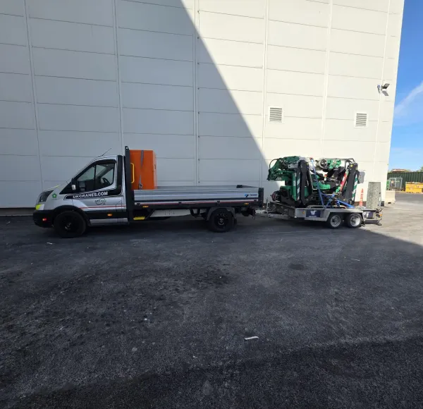 Van towing a spider crane on a trailer