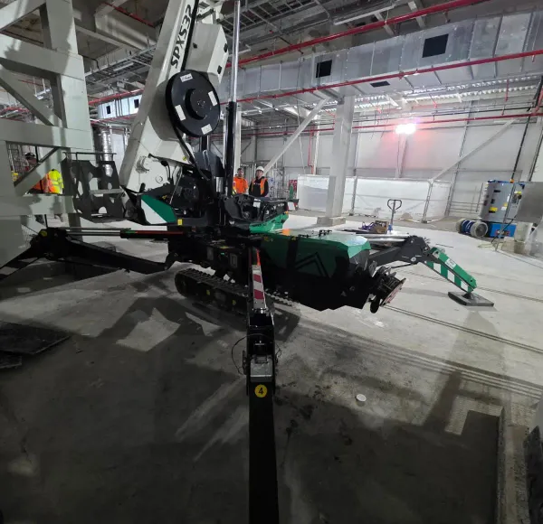 Spider crane lifting inside an industrial building