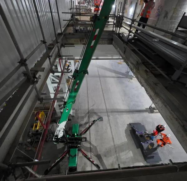 Spider crane with its boom extended in a plant room