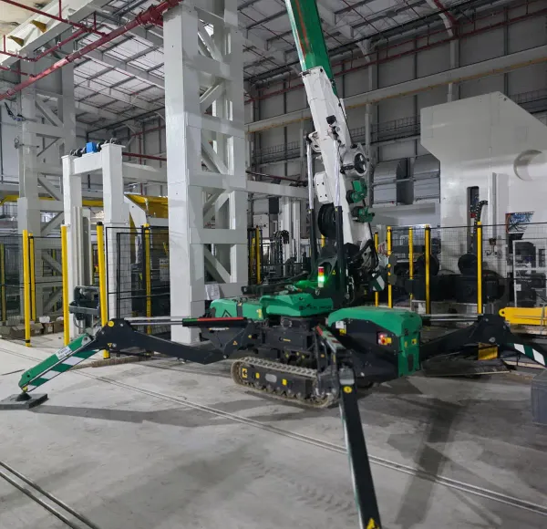 Spider crane lifting steel beside a structure