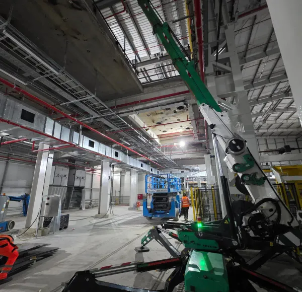 Spider crane operating in an industrial building