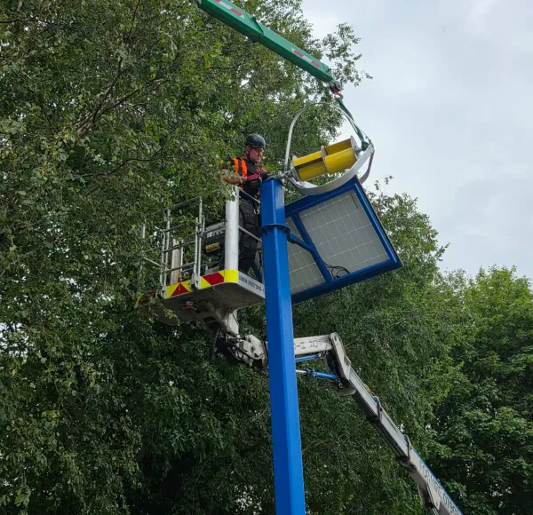 Spider crane lifting a streetlight lantern
