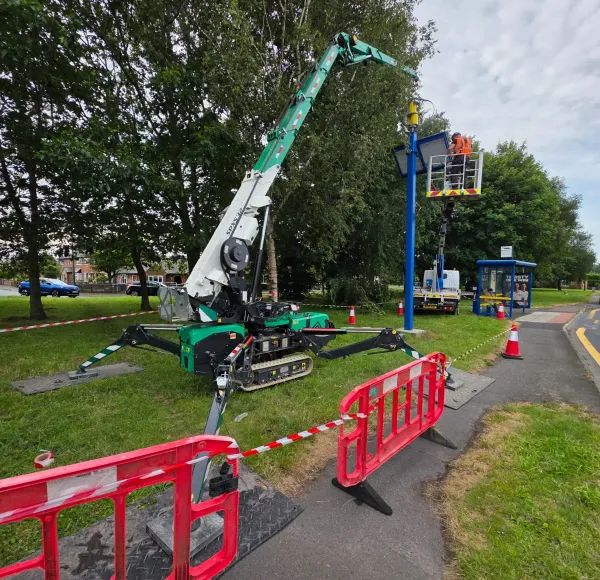 Spider crane working behind red safety barriers