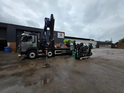 HIAB lorry and compact crawler crane working in an industrial yard